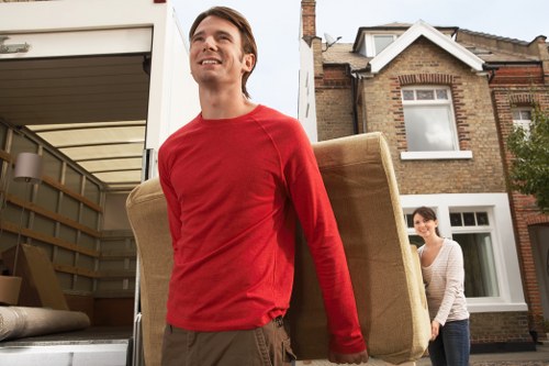 Professional movers loading household items into a van in Southfields