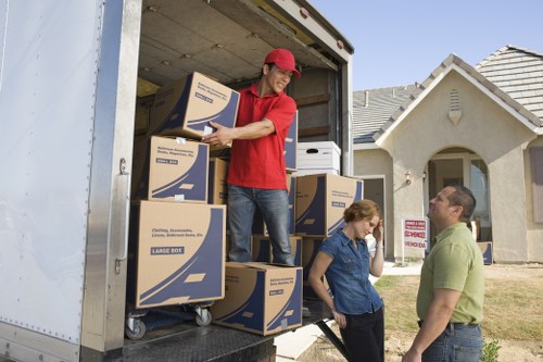 Boxes and furniture being loaded into a van for a local move