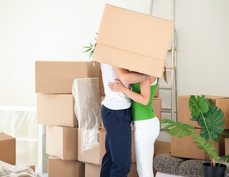 Removal team carrying furniture through a Southfields street