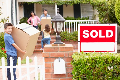 Professional movers loading household items into a removal van
